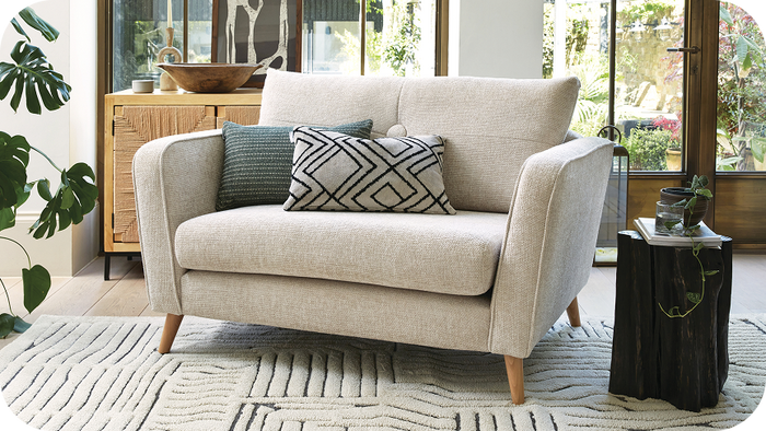 Cream accent chair with green and patterned scatter cushions