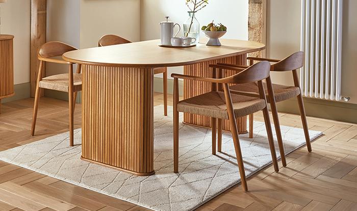 Oak veneer ribbed dining table with four wooden chairs
