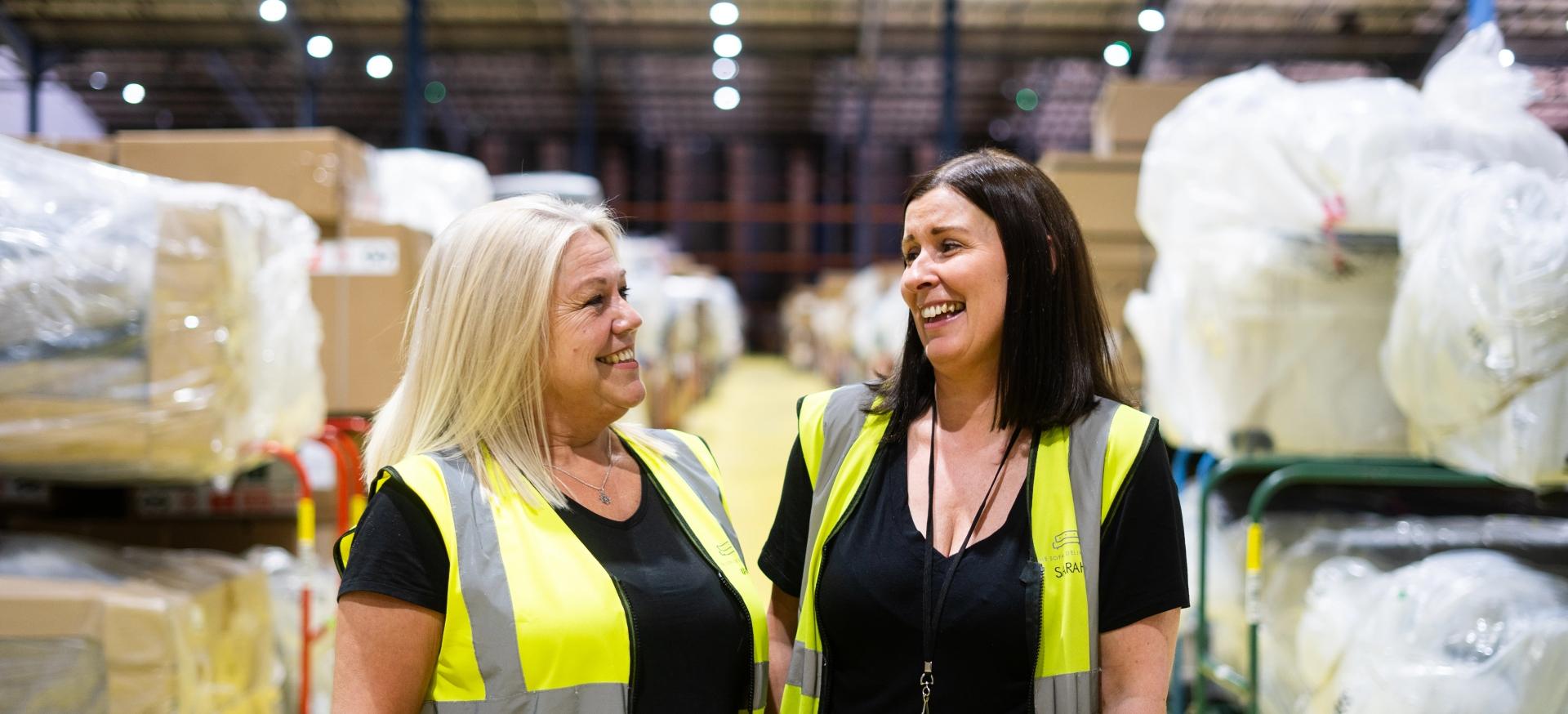 Two women in high vis vests