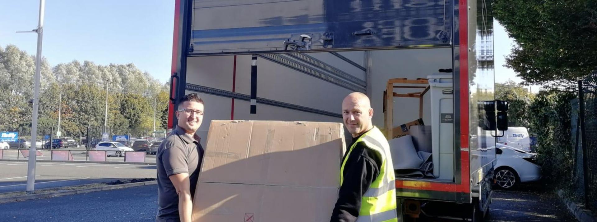 Two men unloading a truck